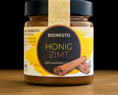 Aus Bio-Honig mit Ceylon-Zimt besteht die Honig-Zimtcreme von Bienesto - 250g Glas auf Tisch